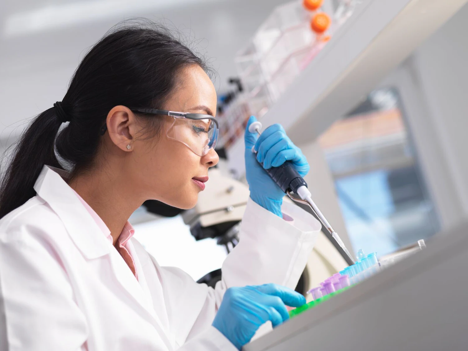 Scientist Pipetting a Sample an Experiment in a Laboratory Clip