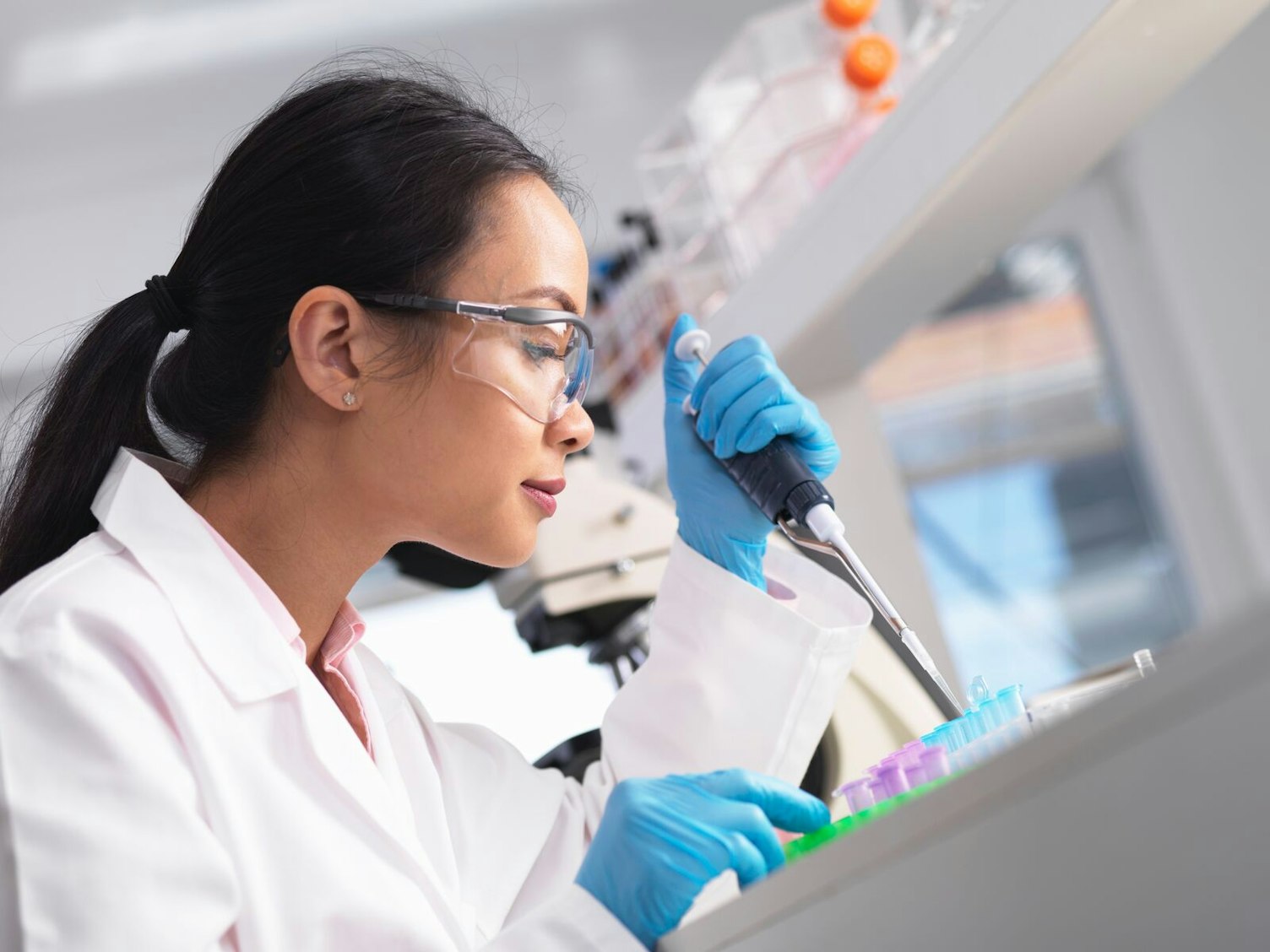 Scientist Pipetting a Sample an Experiment in a Laboratory Clip