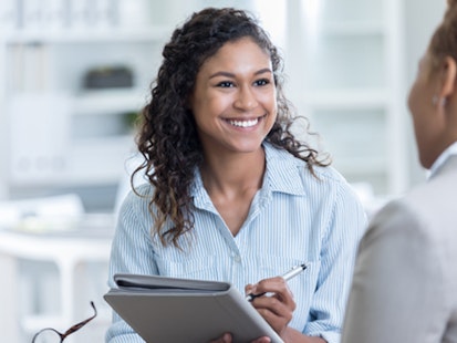 Woman Taking Notes During an Interview