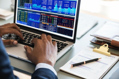 Man Working on a Computer Looking at Data and Graphs