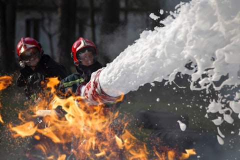 Fire Fighters Extinguishing a Fire with Foam
