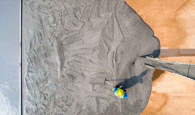 Construction Worker Pouring Wet Concret