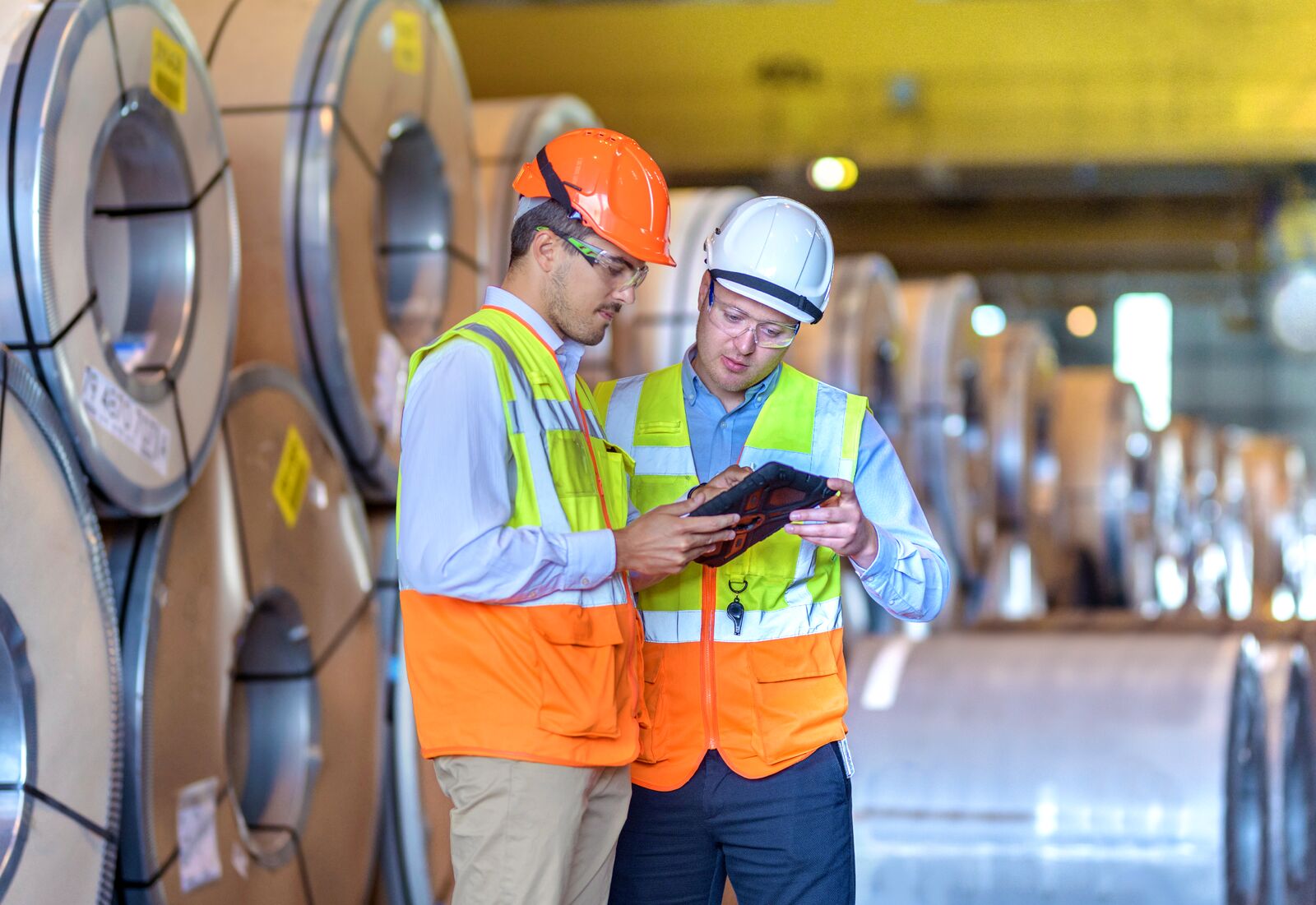 Inspector Using Digital Tablet at Steel Sheet Factory