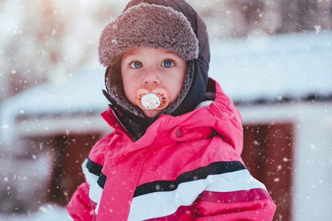 main feature toddler with pacifier in the snow 684px