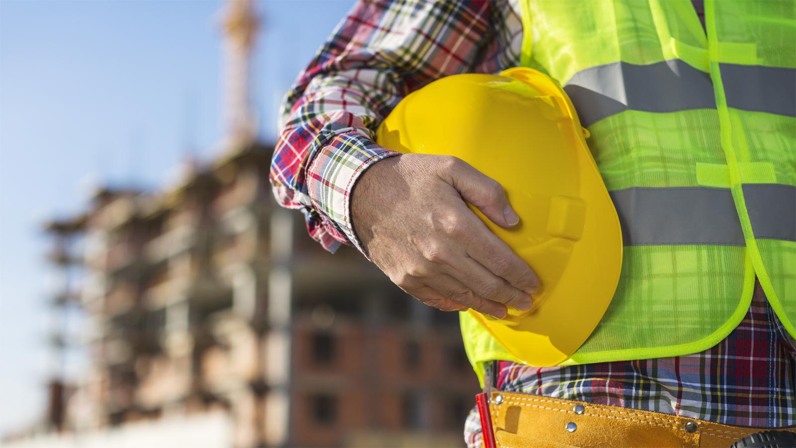 Man holding yellow hard hat