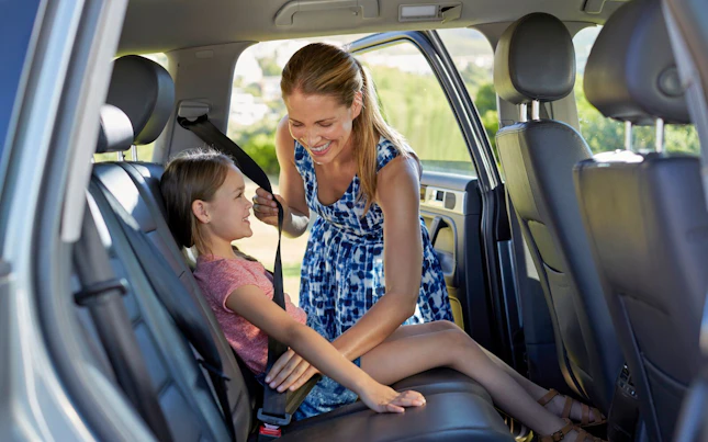 Woman Fastening her Seatbelt in her Car before Driving