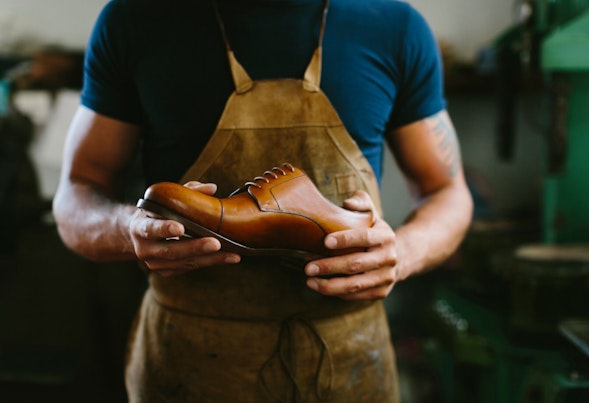 Shoemaker Holding Leather Shoe
