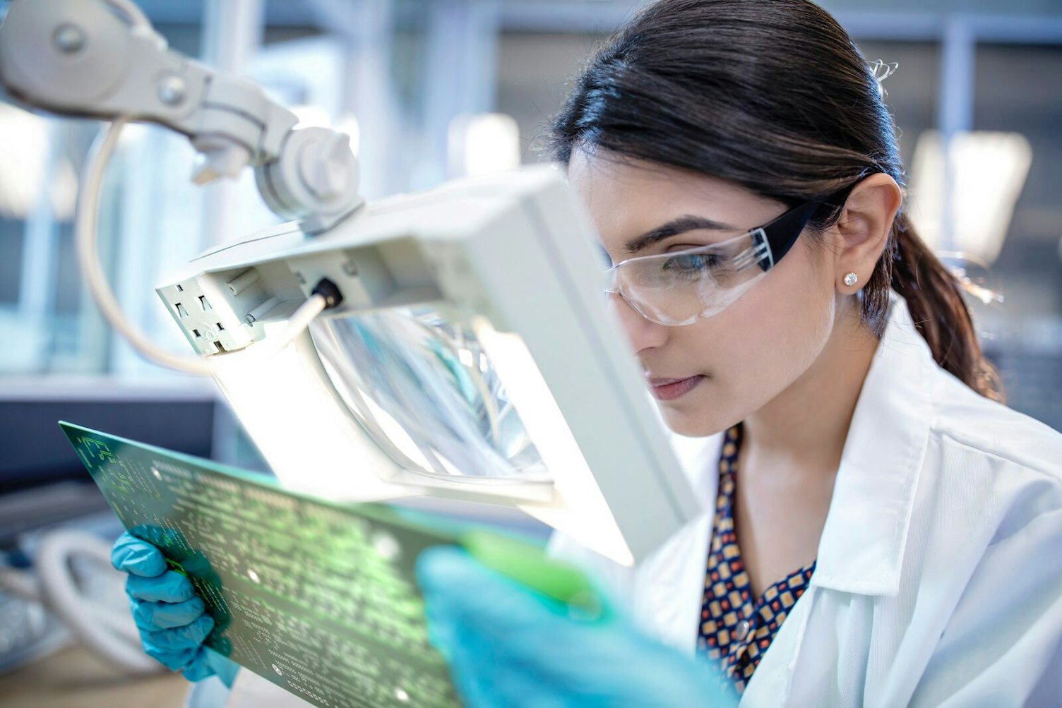 Technician in Laboratory Examining Motherboard