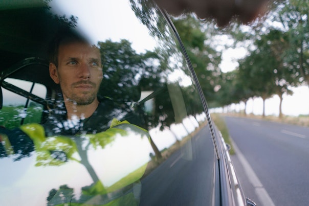 Worker Driving his Car in Country Side